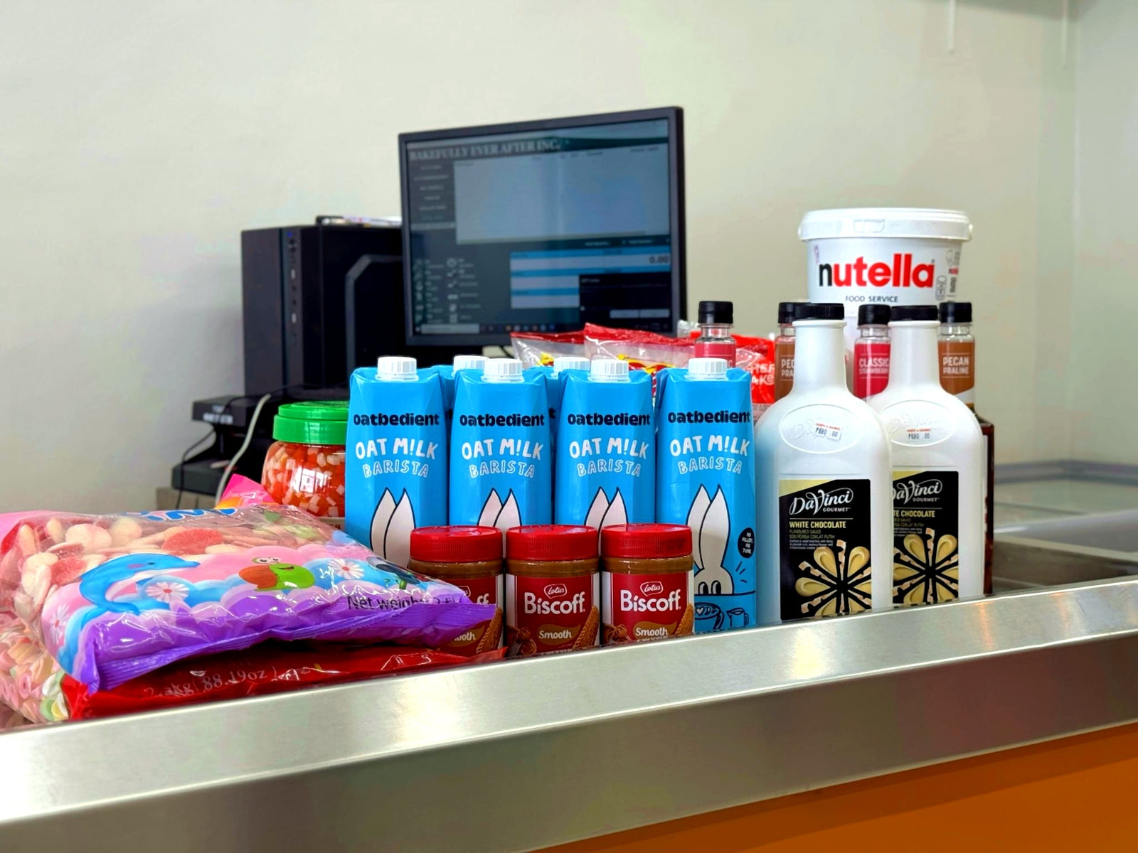 The Chefs and Bakers counter stocked with Oatbedient oat milk, Biscoff, Nutella, and DaVinci syrups